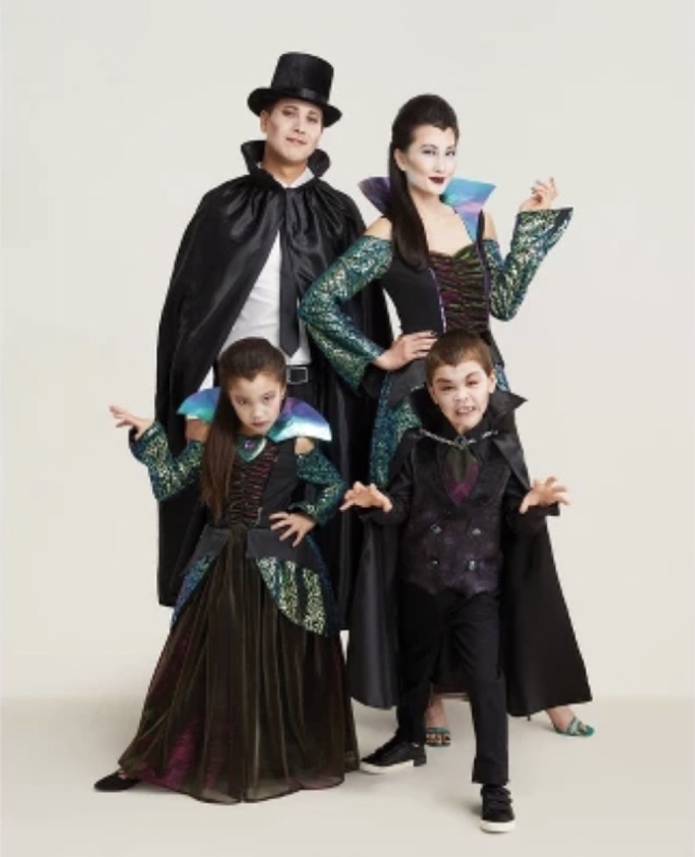 man, woman, and two small children dressed as vampires, family halloween costumes