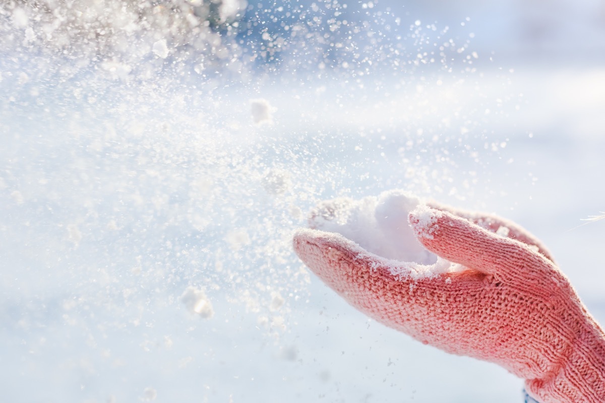 glowed hands holding snow