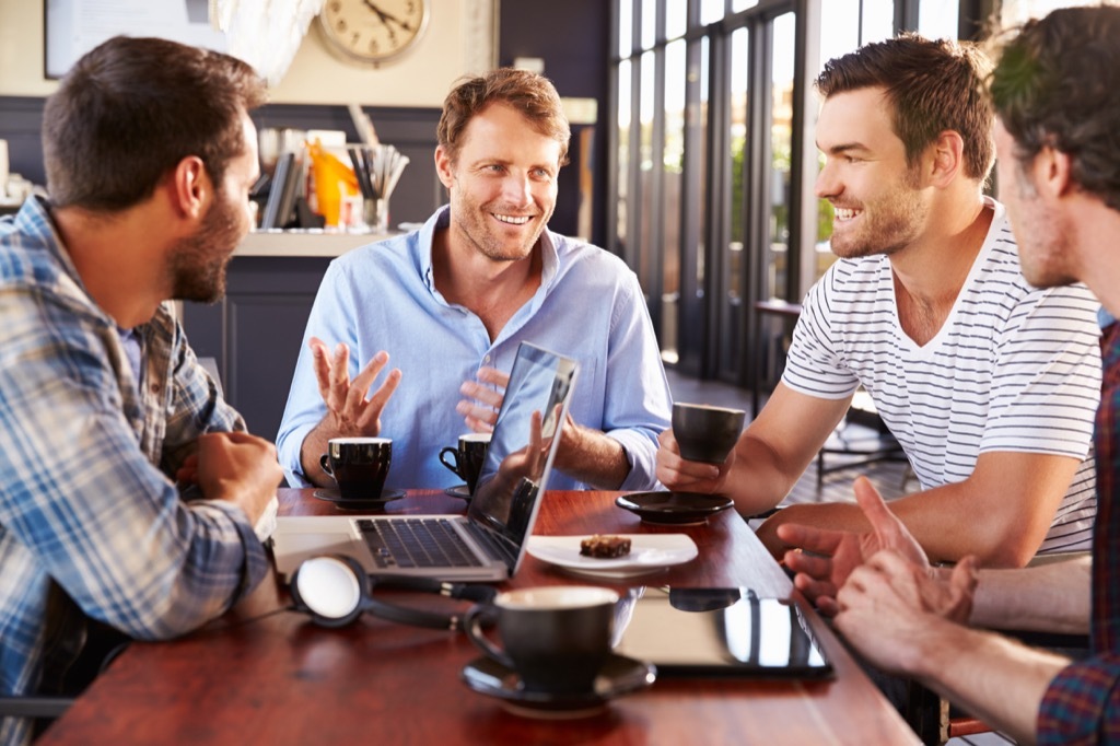 man talking to his three guy friends