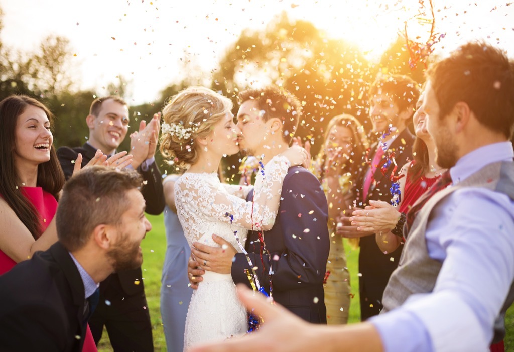 bride kissing groom at an outdoor wedding