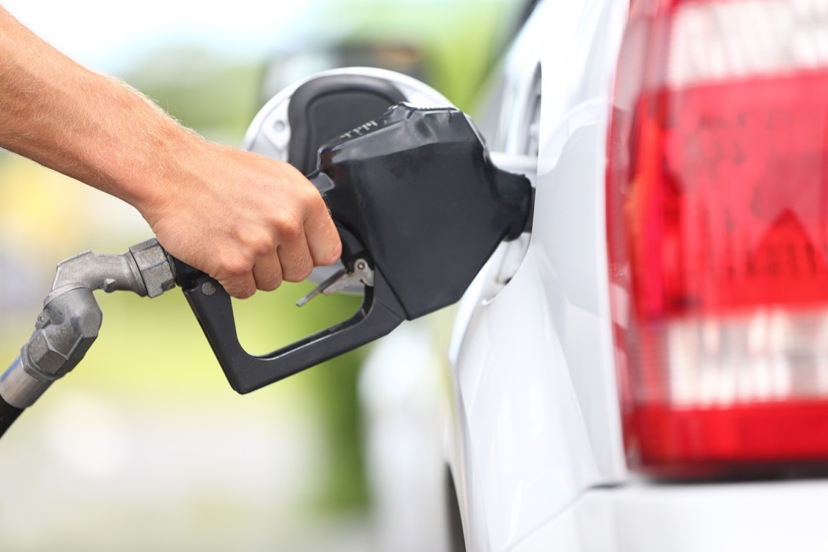 white hand pumping gas