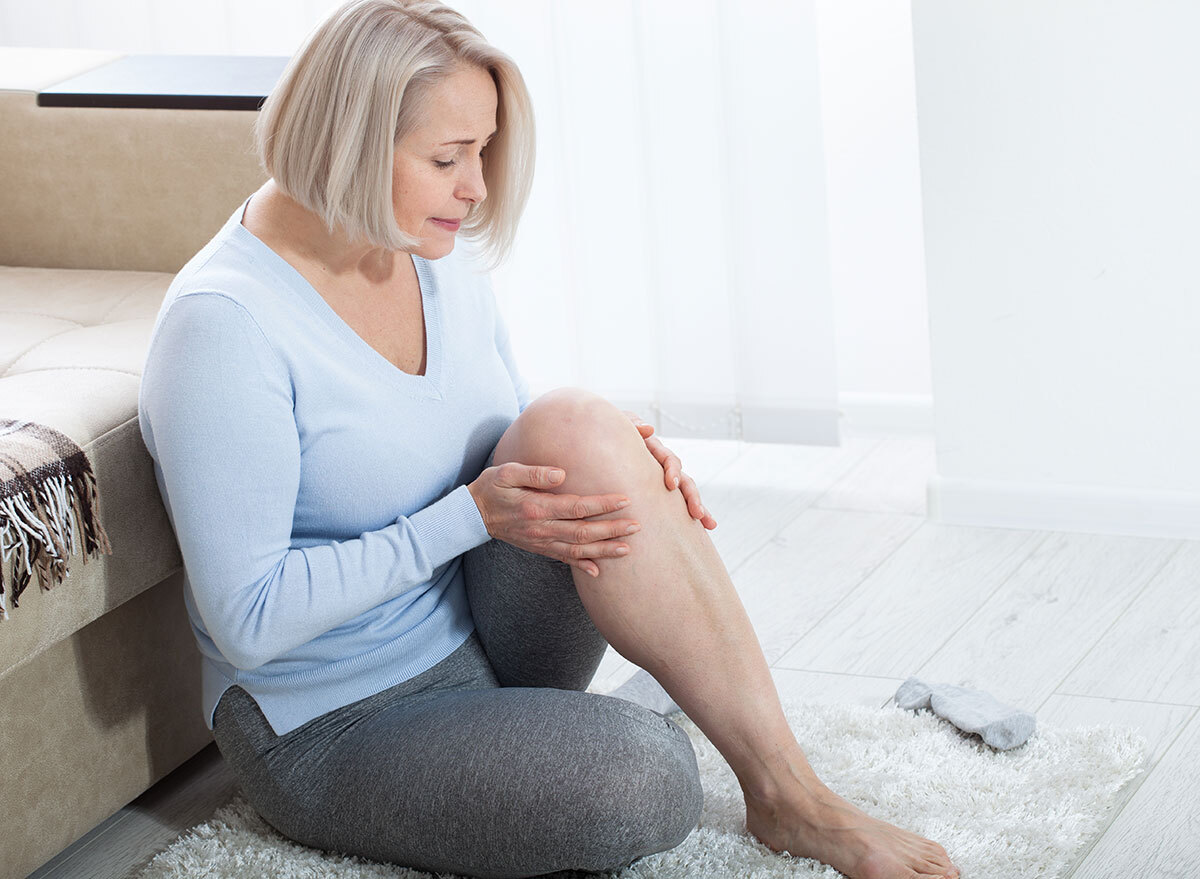 Woman holding leg in pain