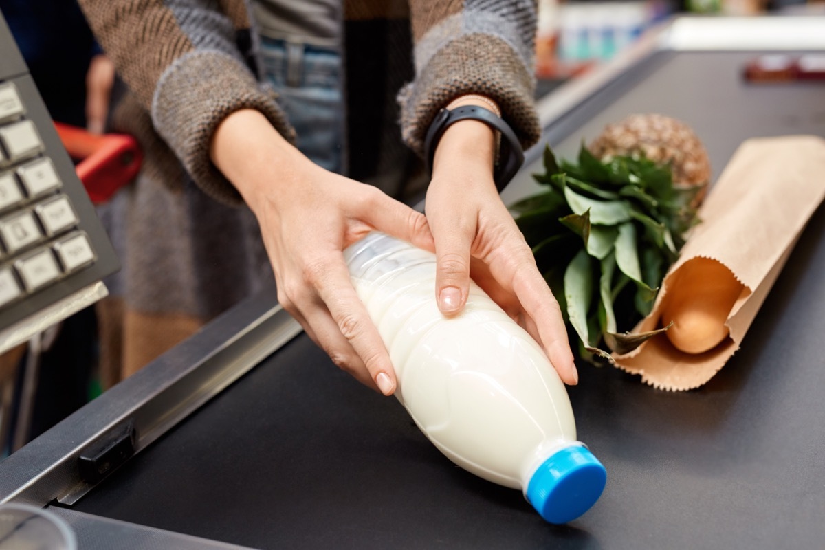 putting groceries on conveyer belt