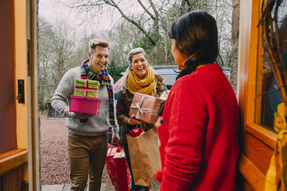 guests arriving at holiday party to the front door