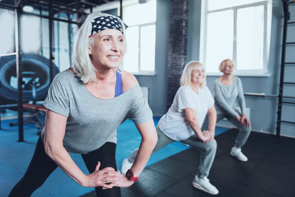 senior women doing lunges at the gym