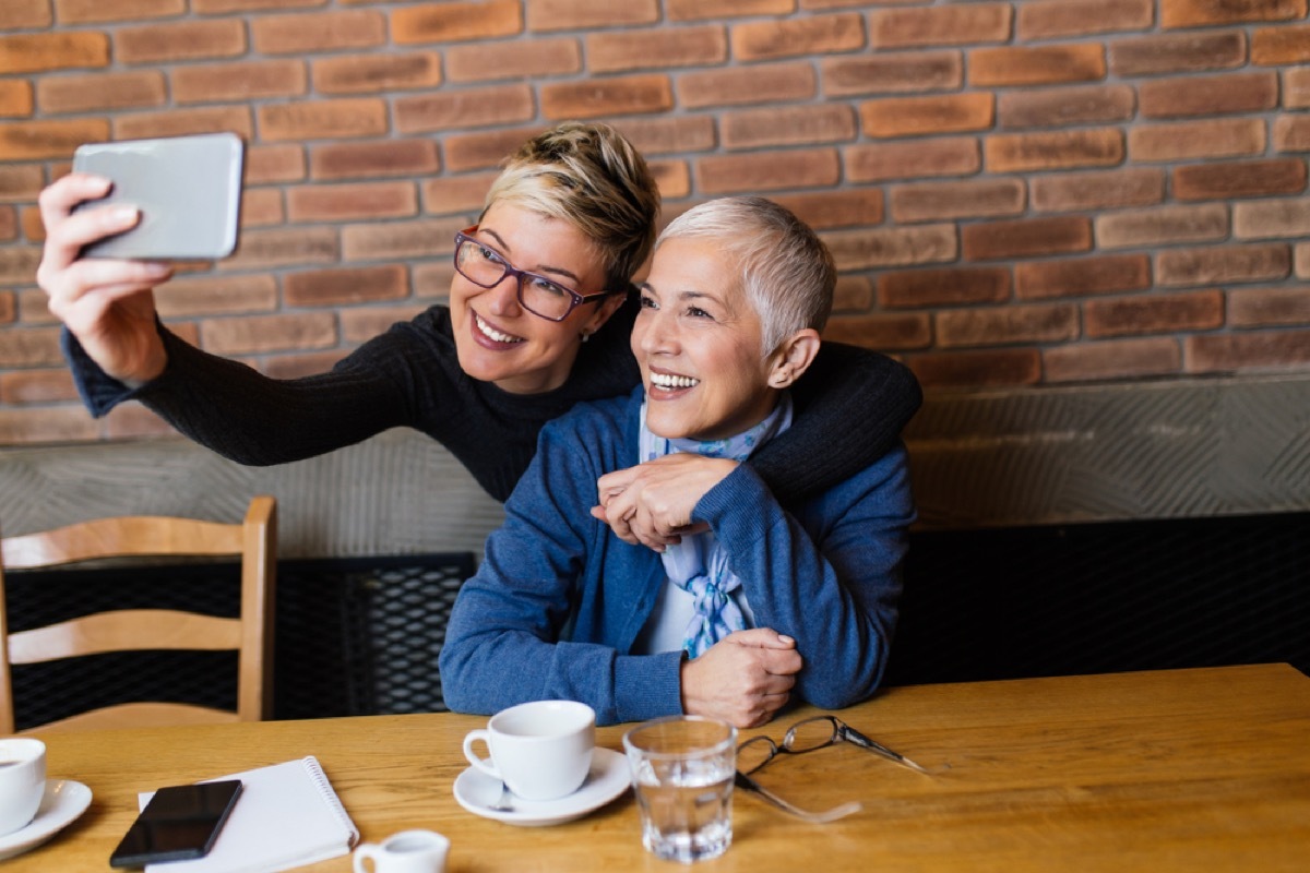 older women taking selfie, female friend