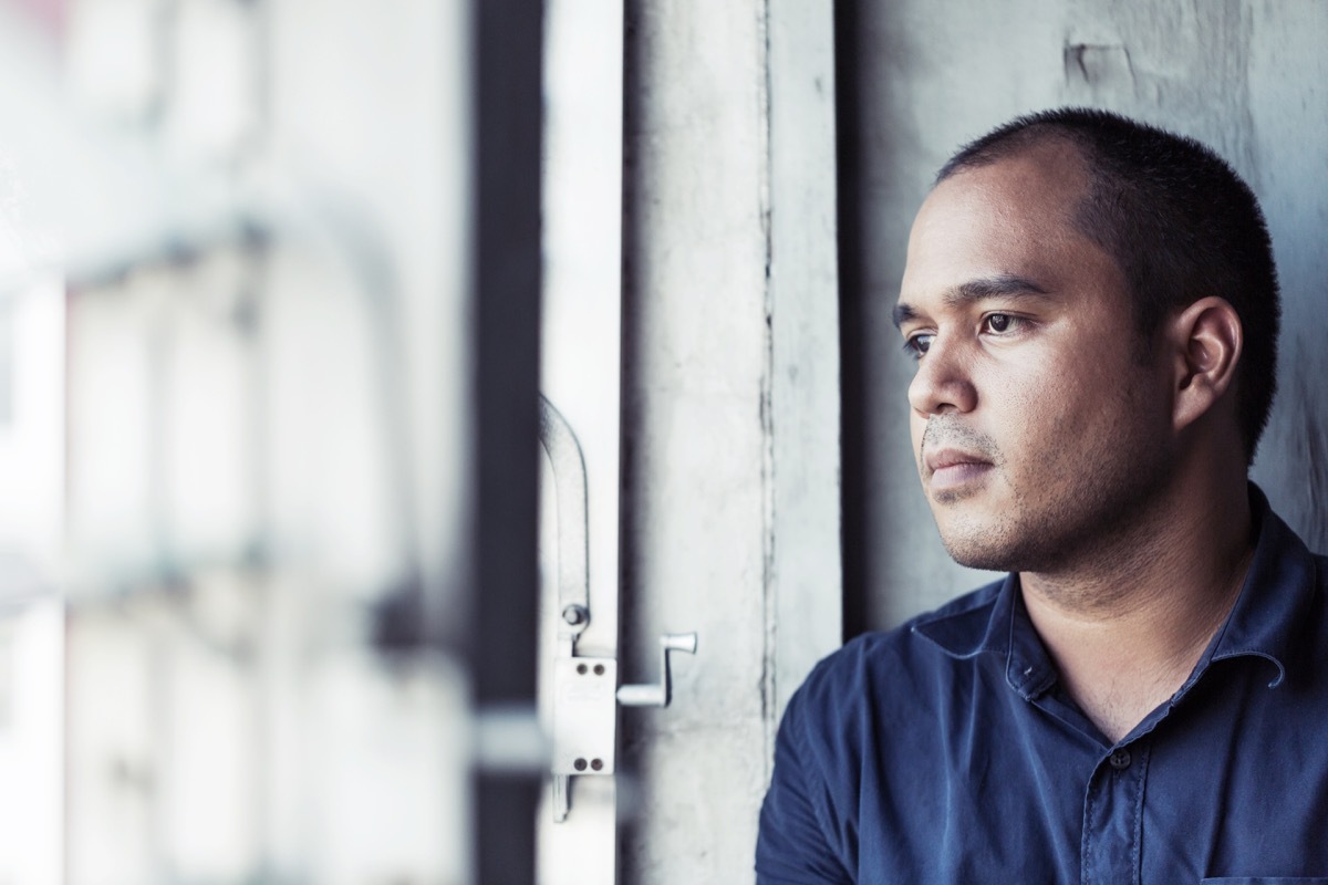 depressed man sitting in dark room