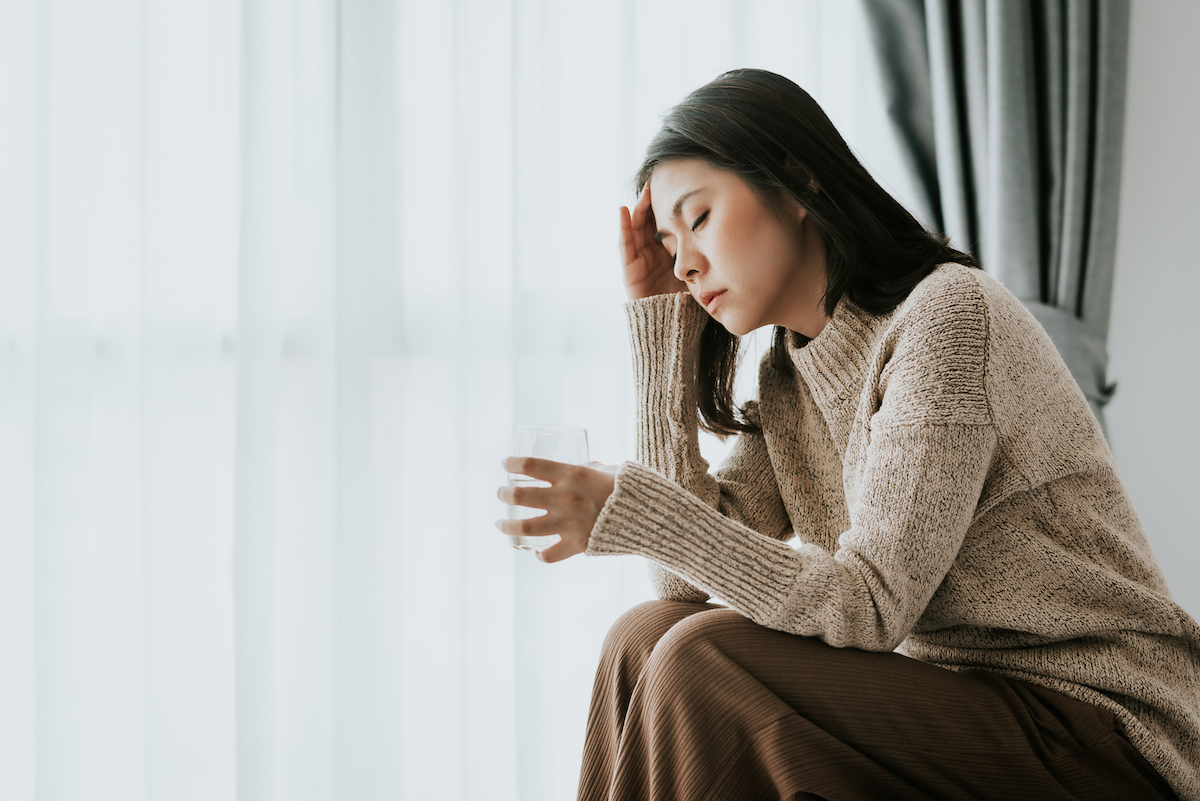 Asian woman not feeling well