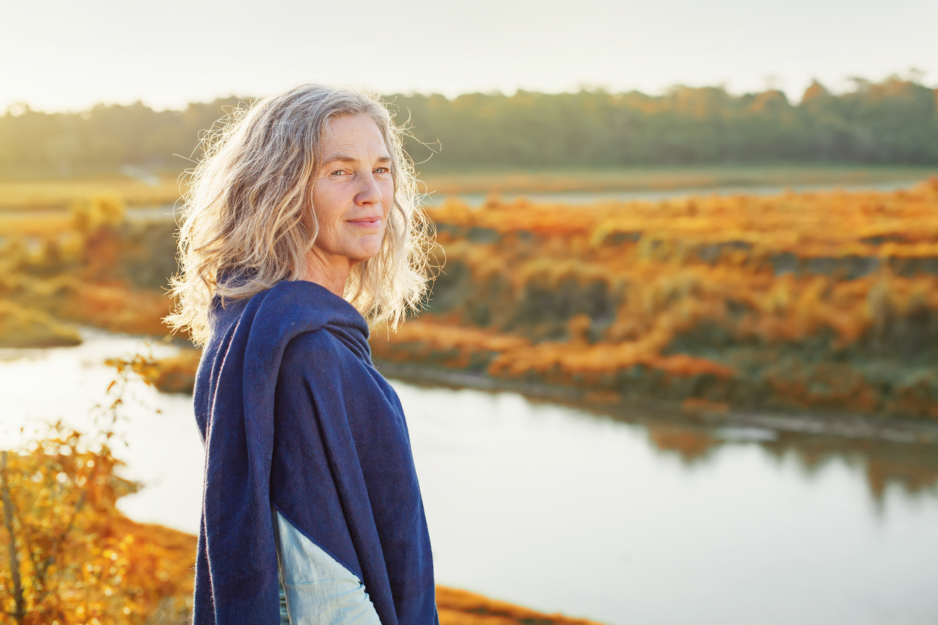 Beautiful,Mature,Woman,Standing,In,Front,Of,The,River,In