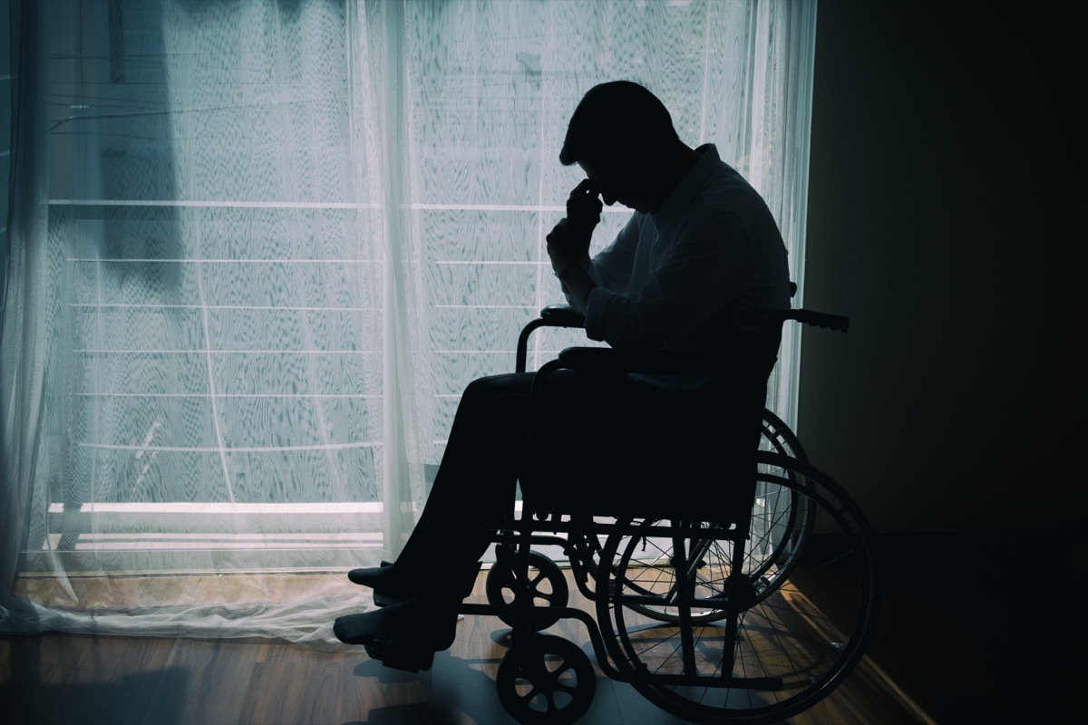 Shadow of man hanging head while sitting in wheelchair, things not to say to people