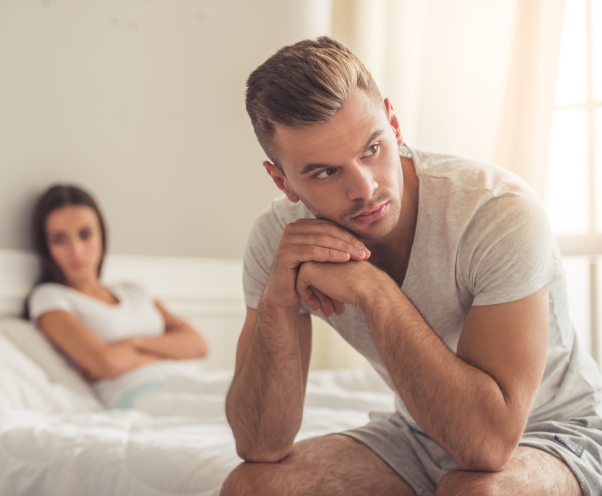 Man looking upset and woman behind him