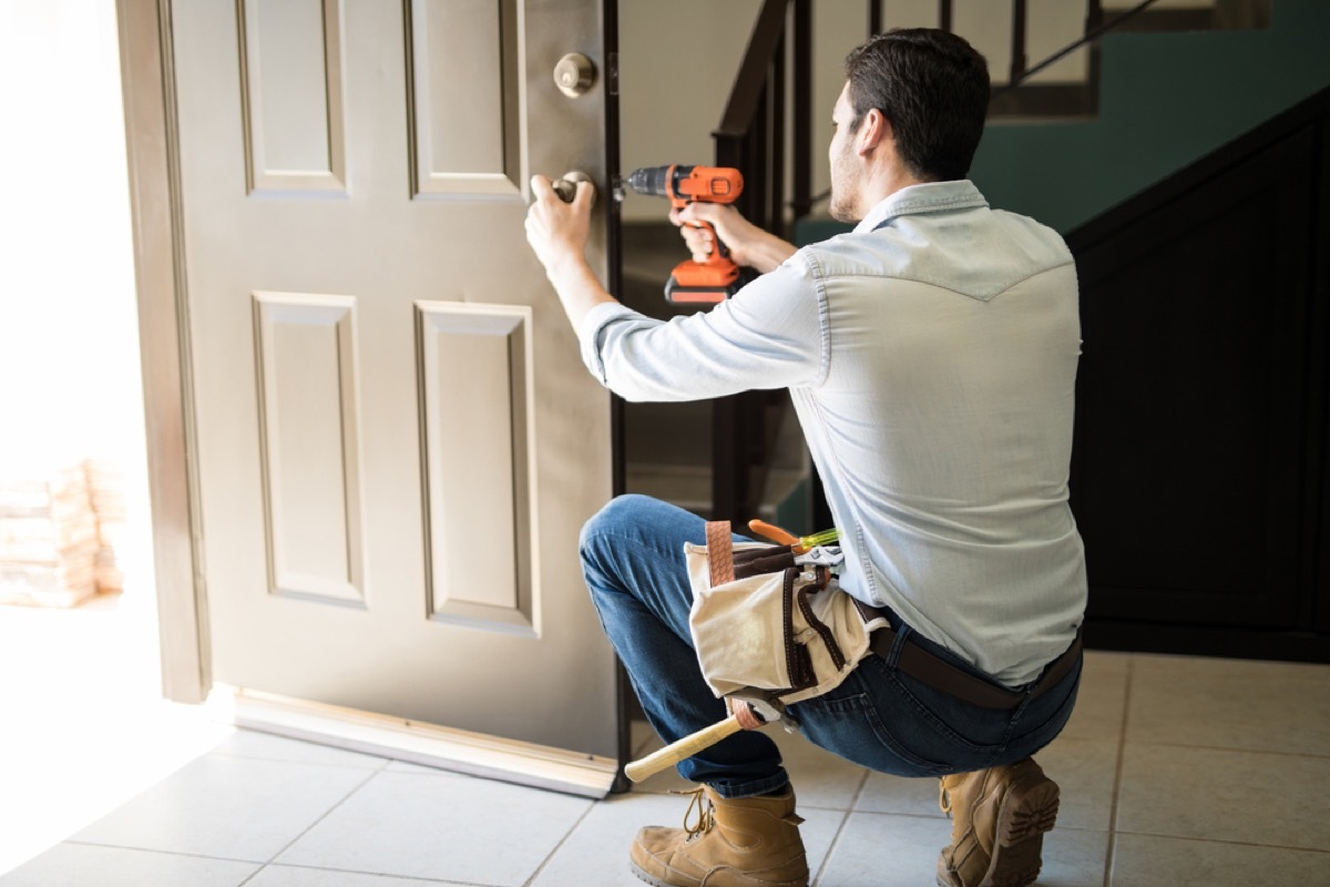 man installing front door lock