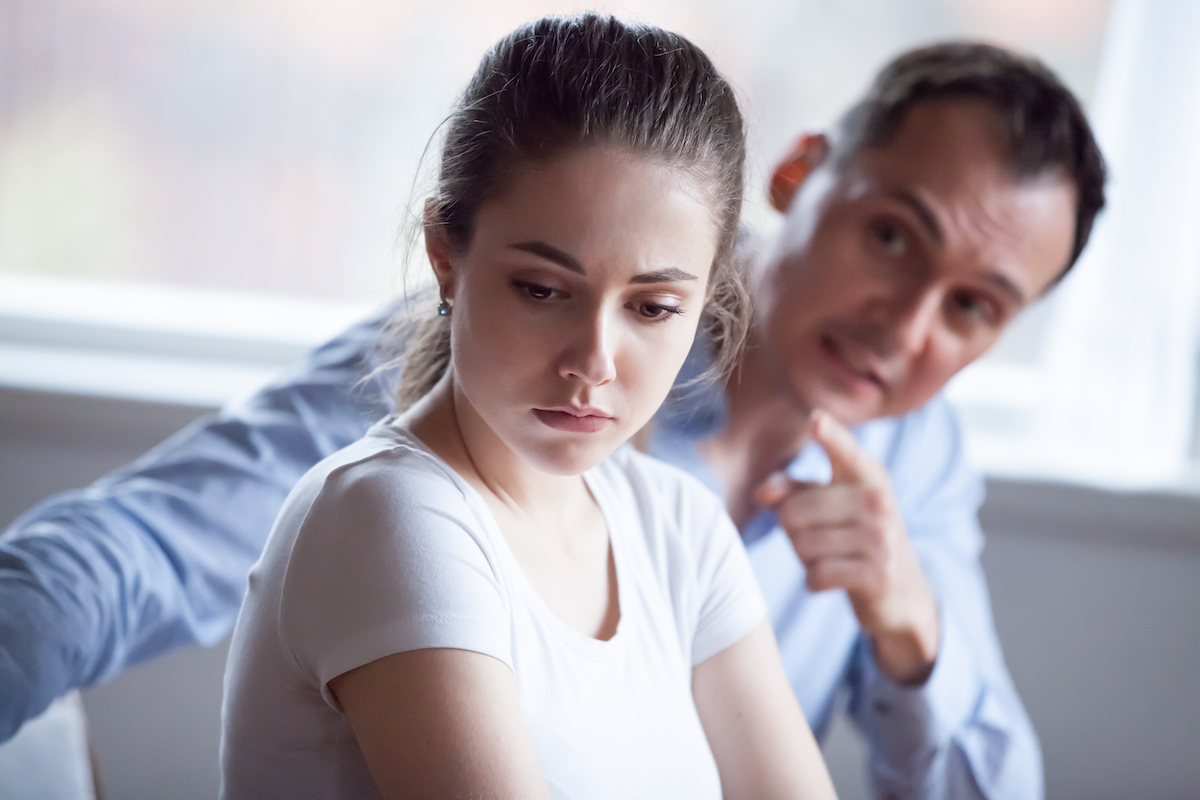 man scolding woman