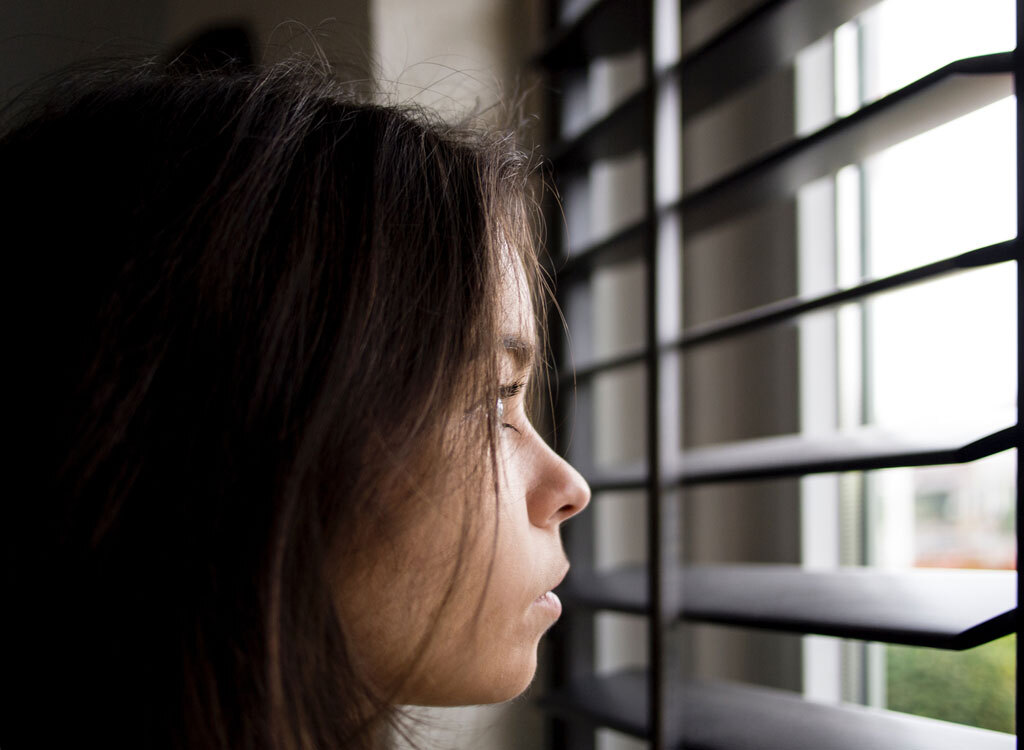 woman staring out window - how to lose weight overnight