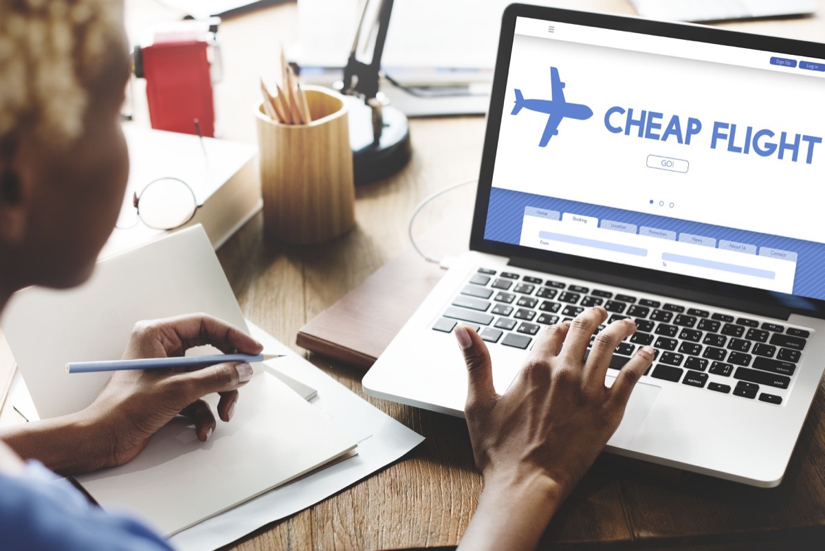 woman checking cheap flights on her laptop