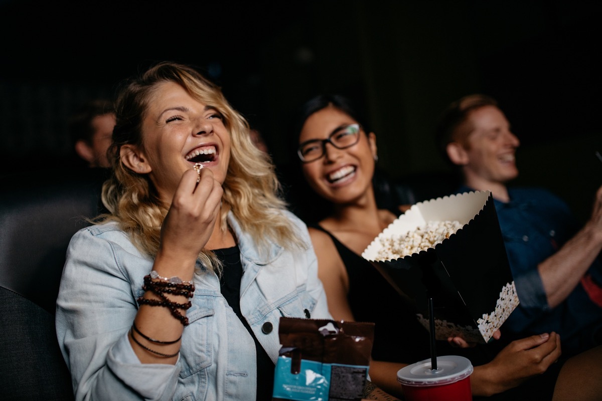 Friends laughing at the movies