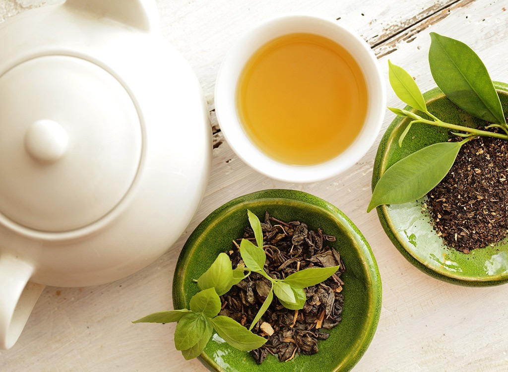 overhead shot of green tea, pot, and plants