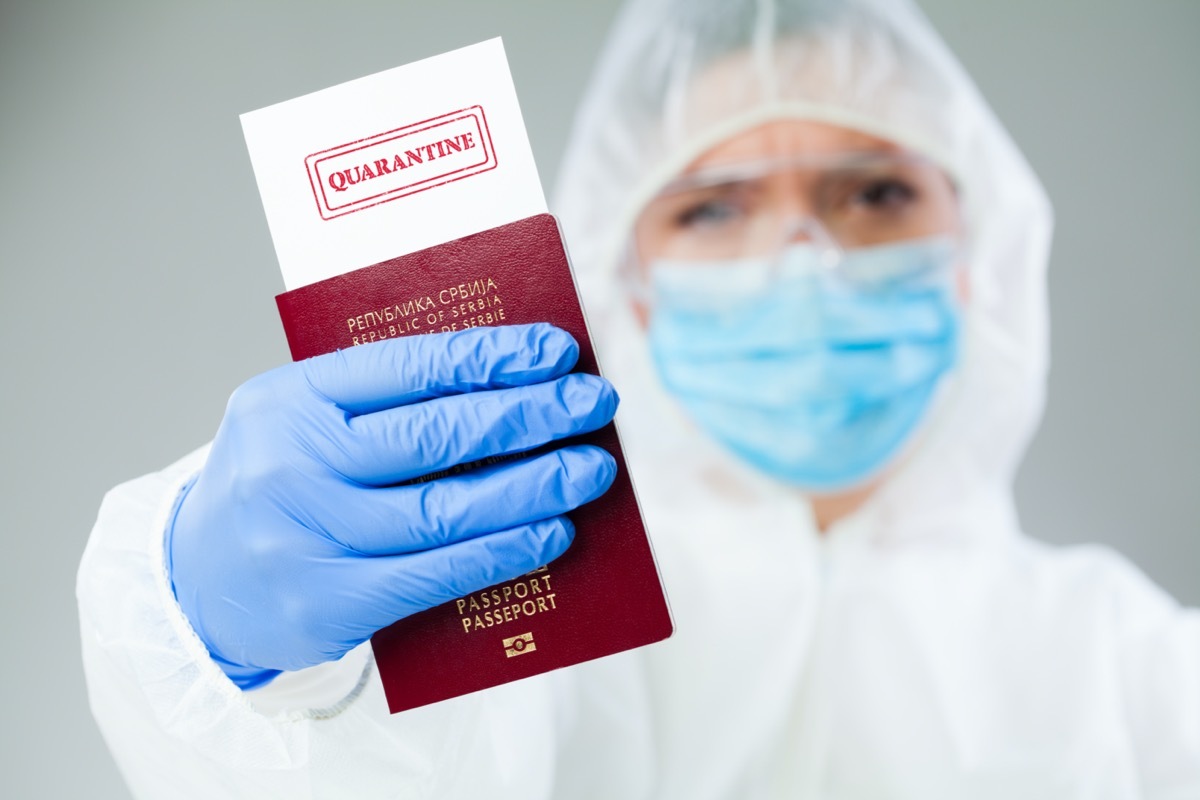 Security officer at airport customs security check holding passport, no entry