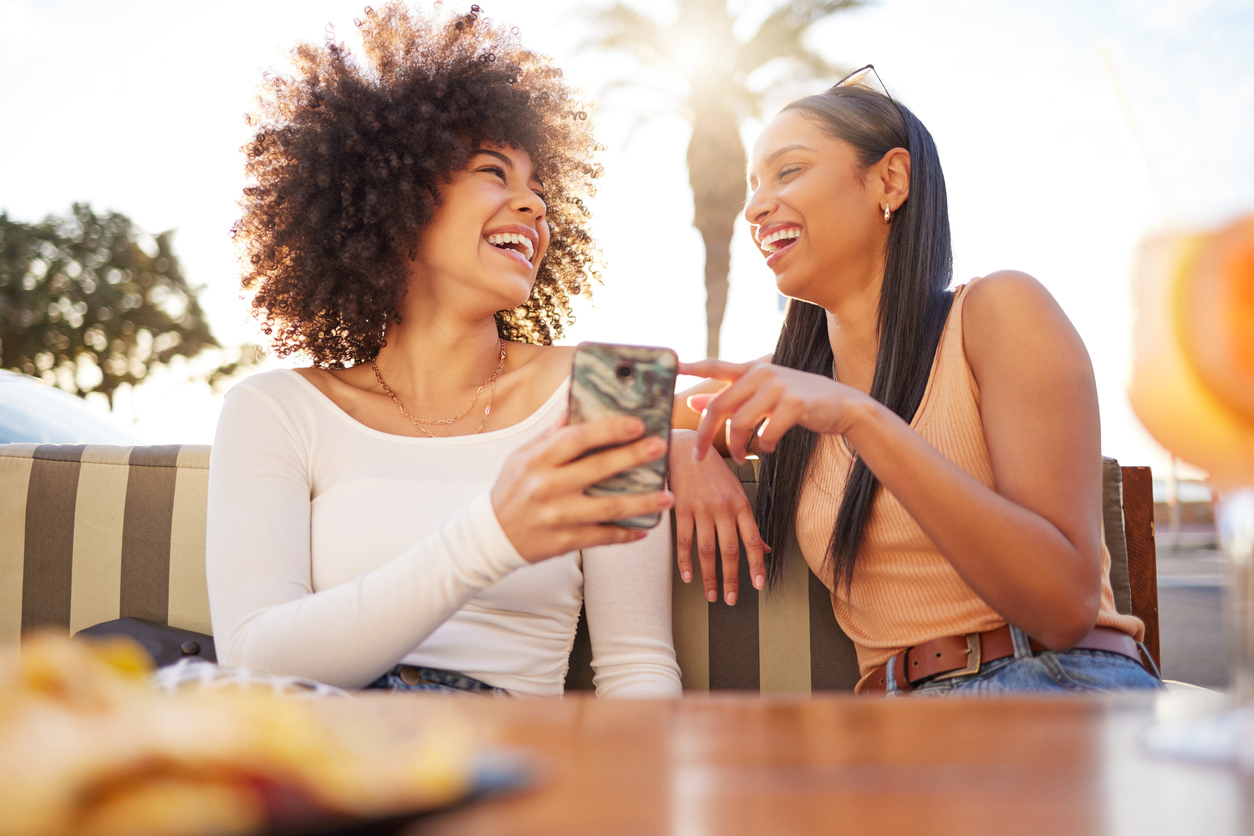 two friends laughing and txting