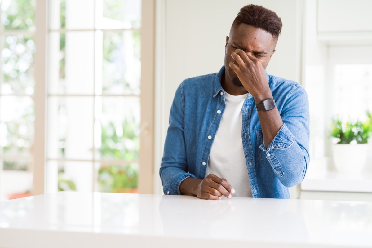 man smelling a bad smell at smelly home, signs your cold is serious