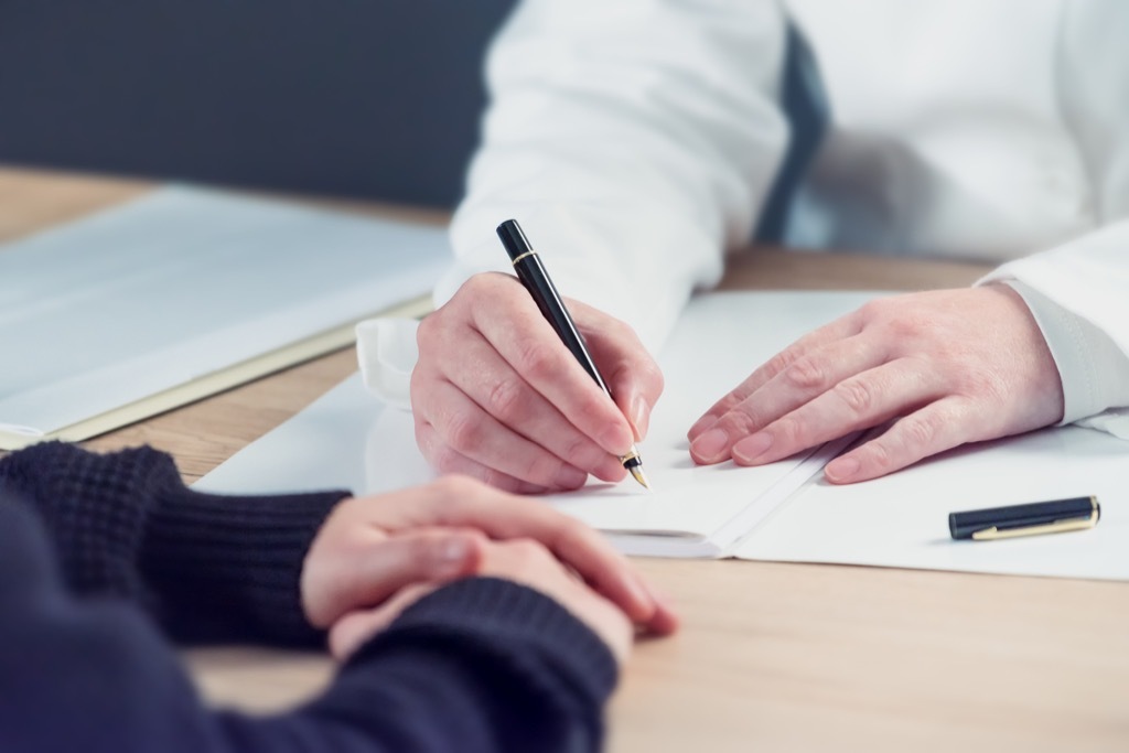 Man signing a document college professor secrets