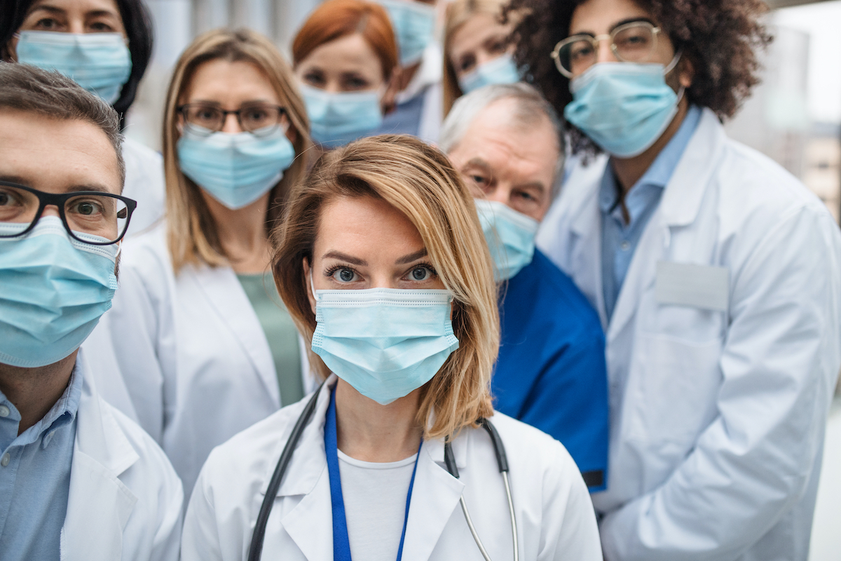 a group of doctors wearing masks and lab coats