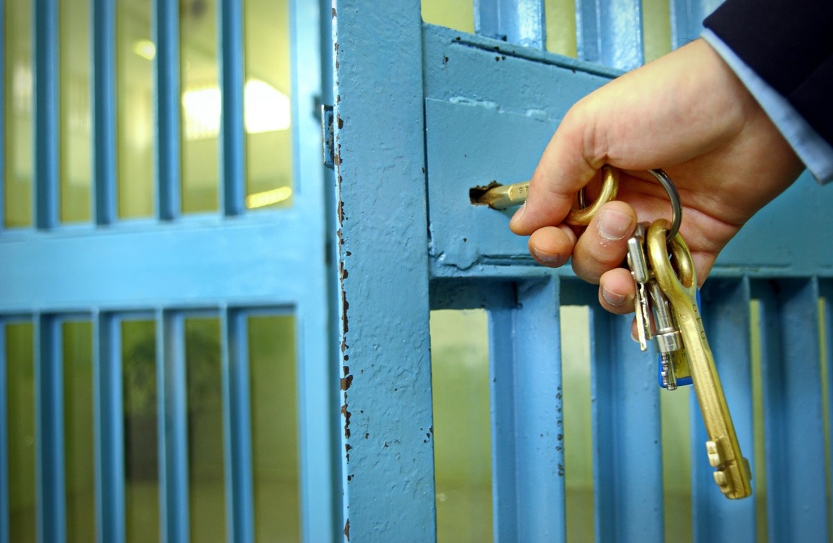 Close up on key locking jail cell