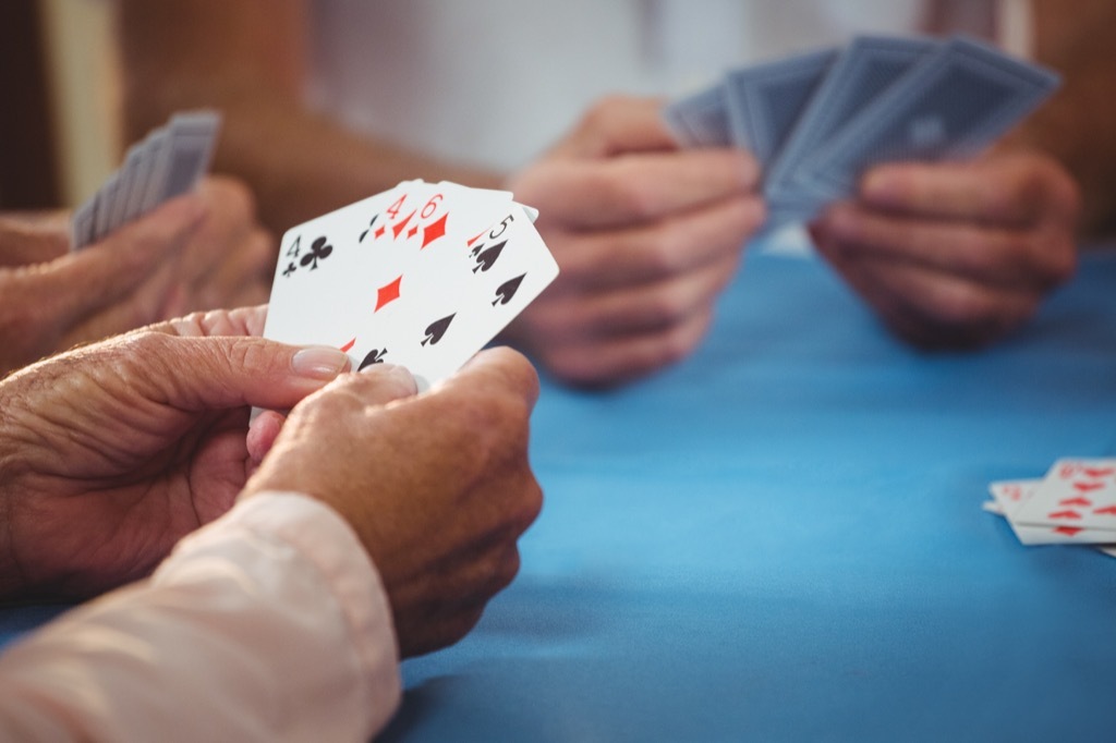 Men's hands holding playing cards