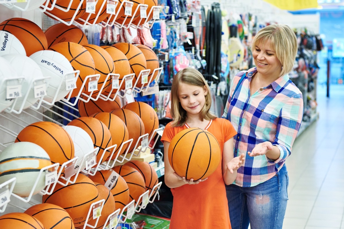 mom buying basketball for daughter