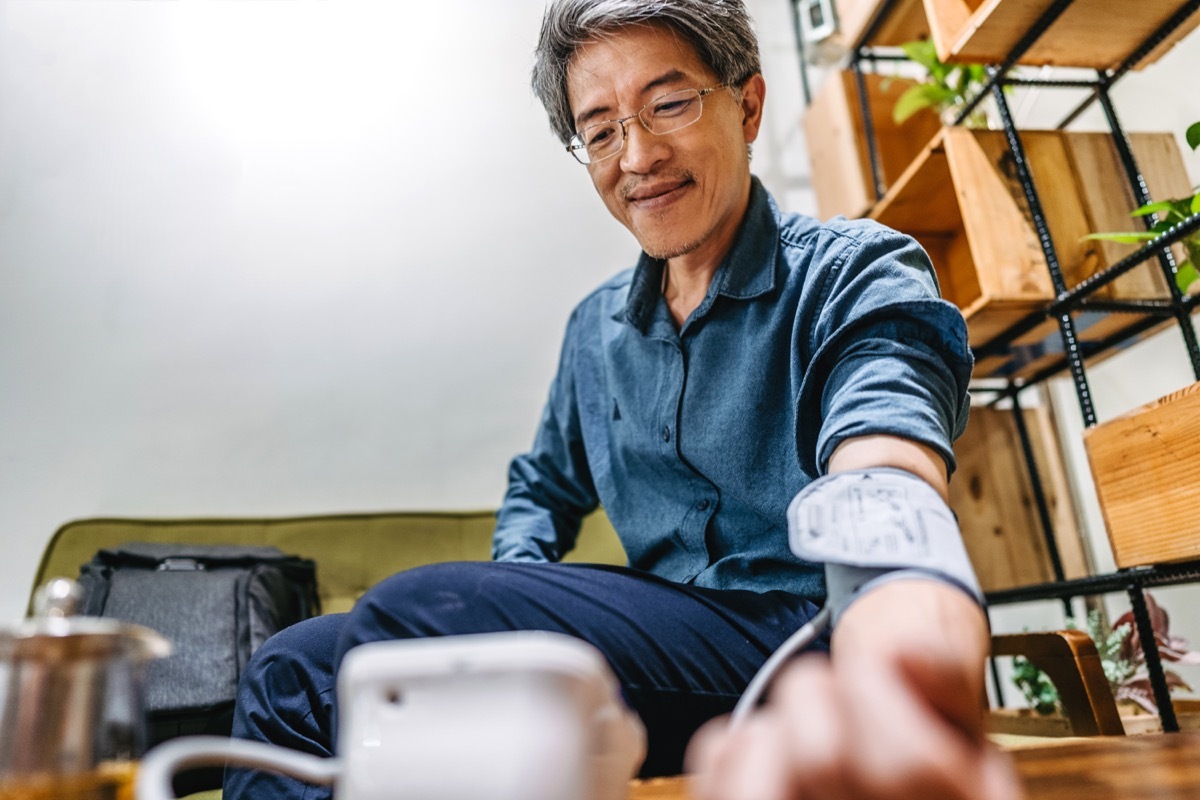 Asian man getting his blood pressure checked