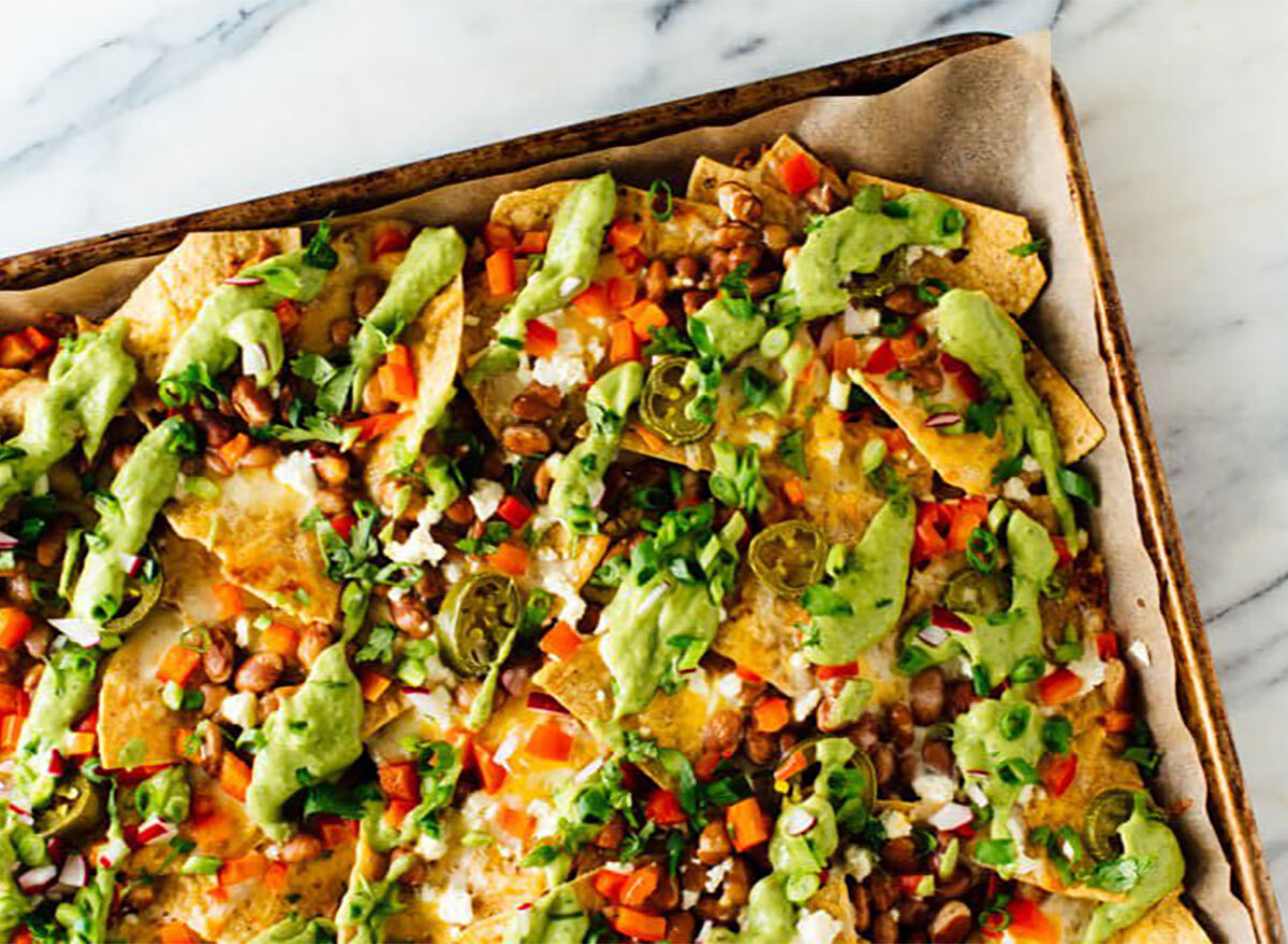 loaded vegetable nachos on a sheet pan