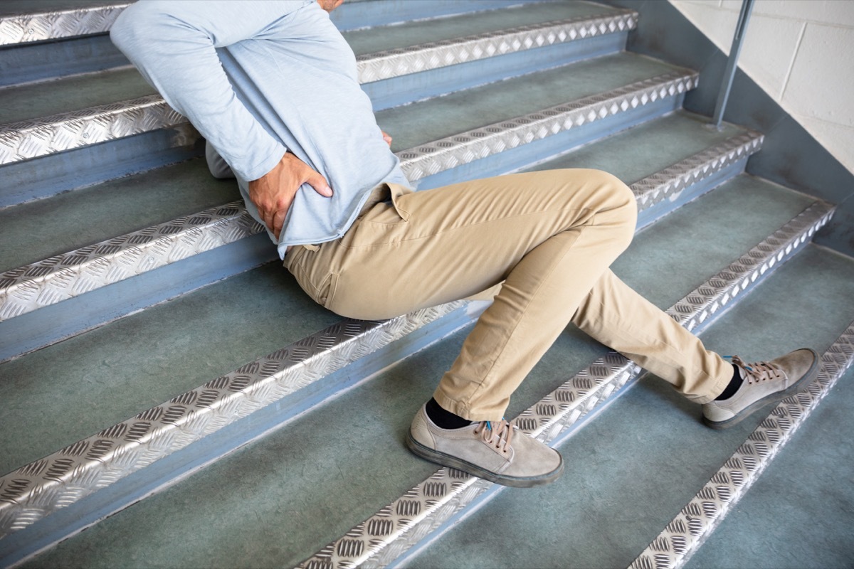 man on the stairs holding his back