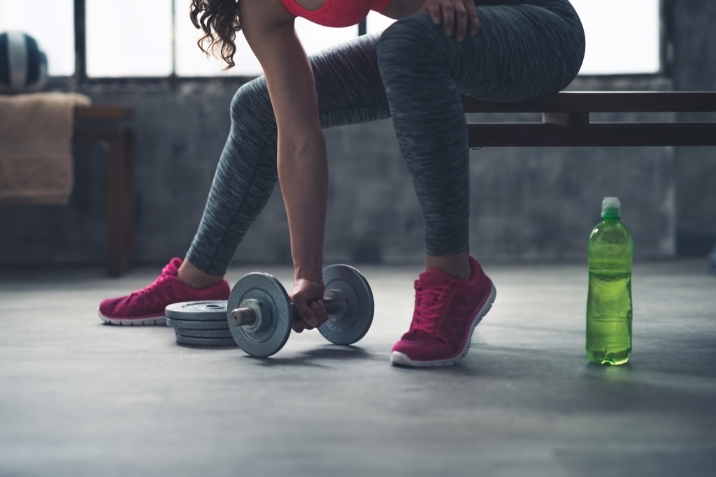 Woman lifting dumbbell Exercises for Adding Muscle