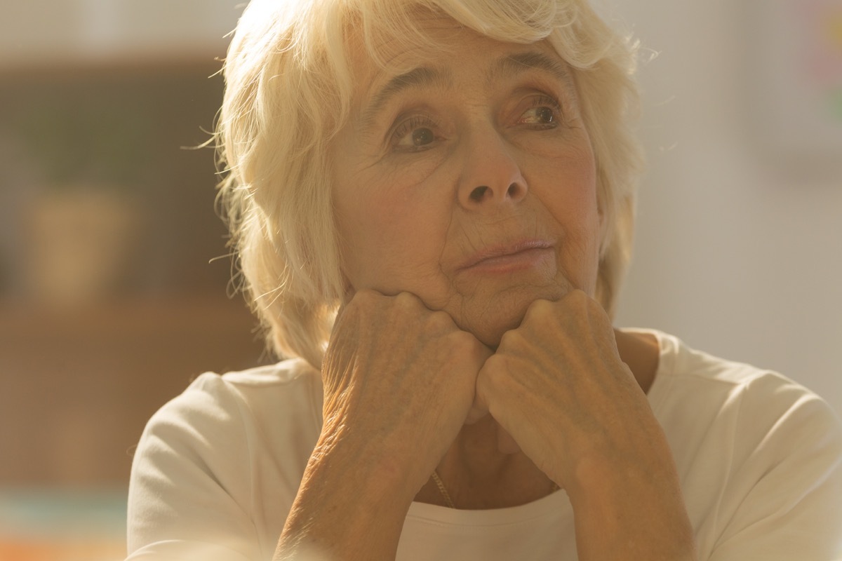 Lonely older woman pondering