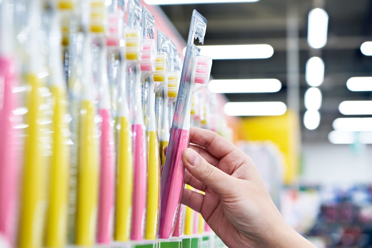 Toothbrush in a package in hand in the store