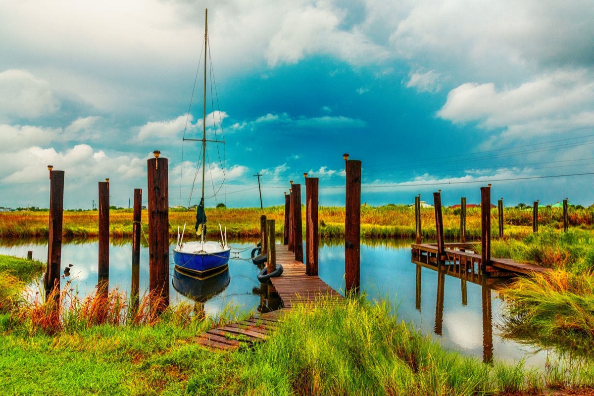 boat docked in the channel next to tress in New Orleans, Louisiana