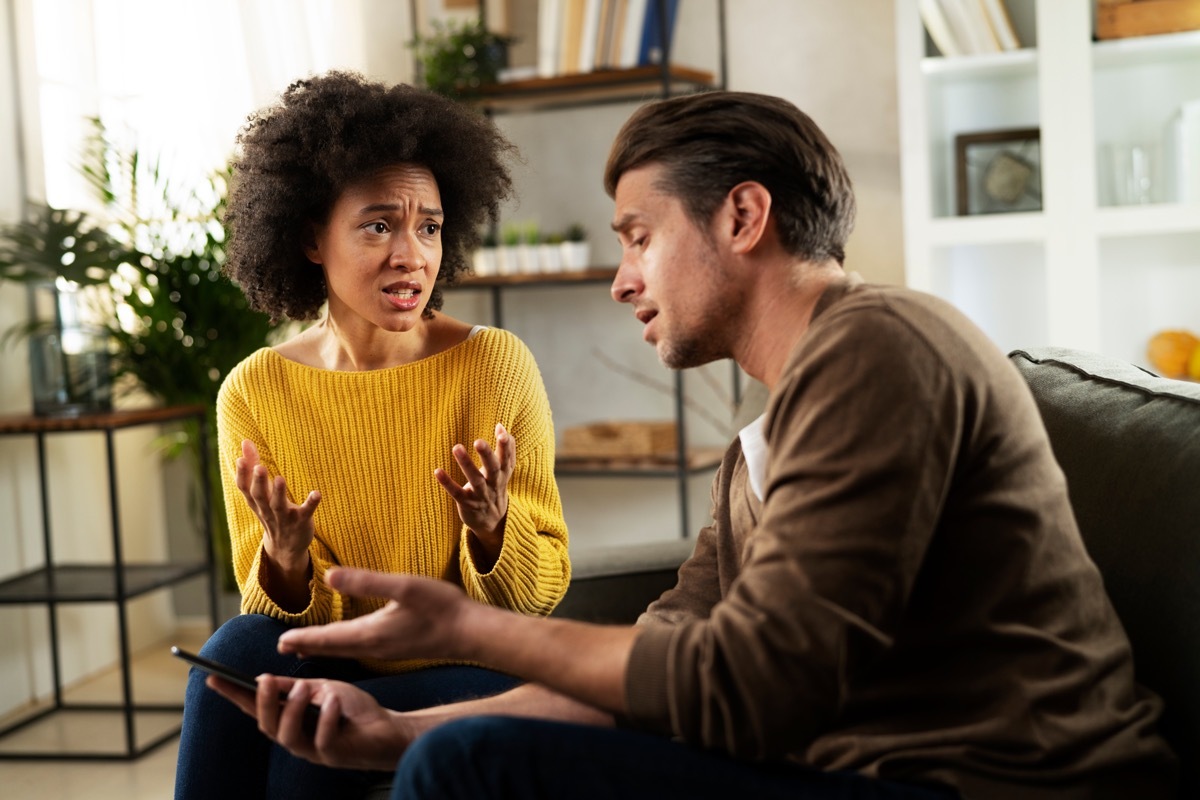 Couple arguing on the cough with one another