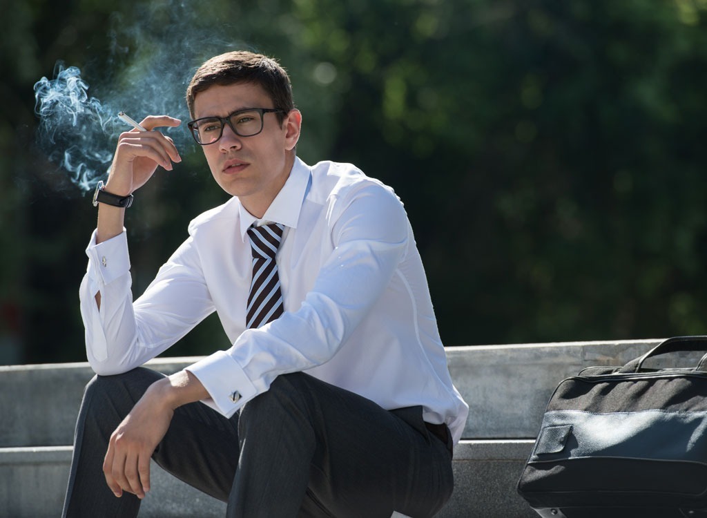 well dressed man smoking