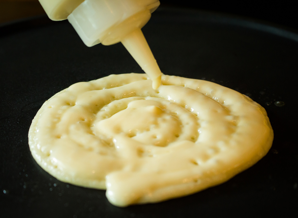 pancake batter in squirt bottle on griddle