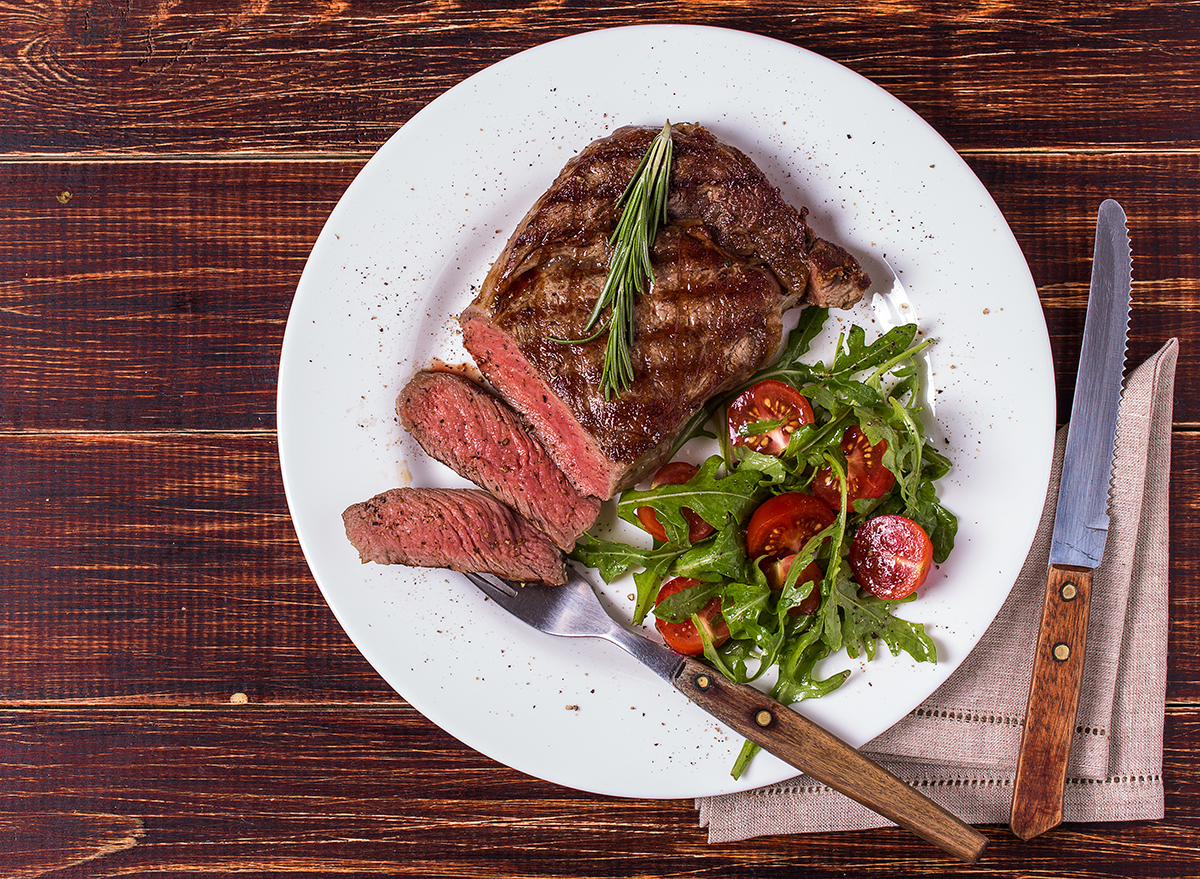 sliced steak sirloin with an arugula and cherry tomato salad