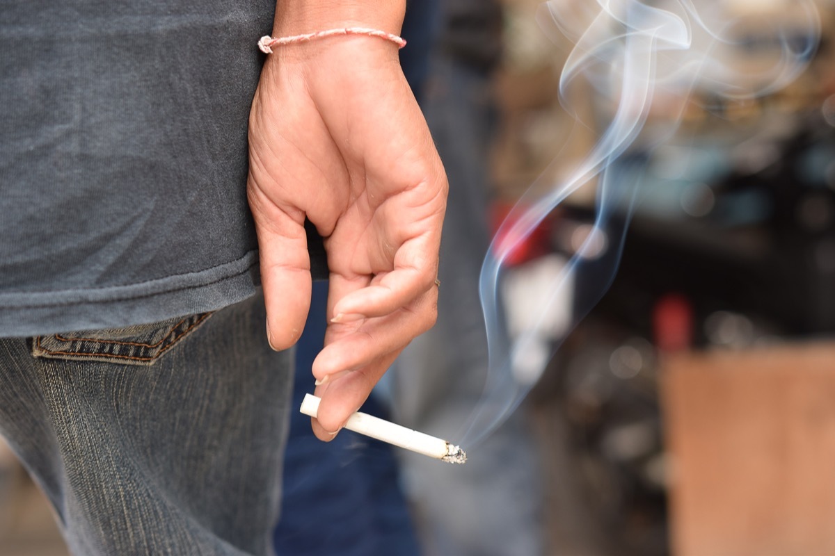 Man Holding a Lit Cigarette