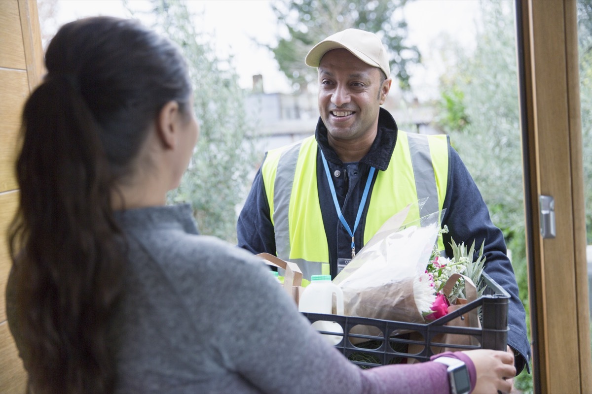 food man delivering groceries to woman