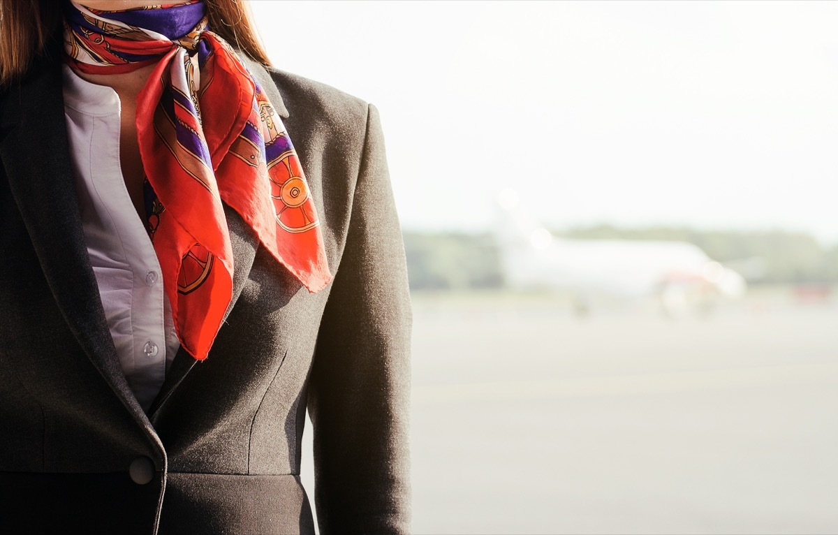 close up on flight attendant, no face shown, just scarf and jacket, flight attendant annoyances