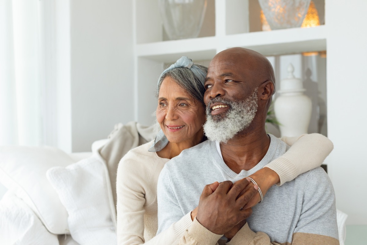 happy senior couple on couch